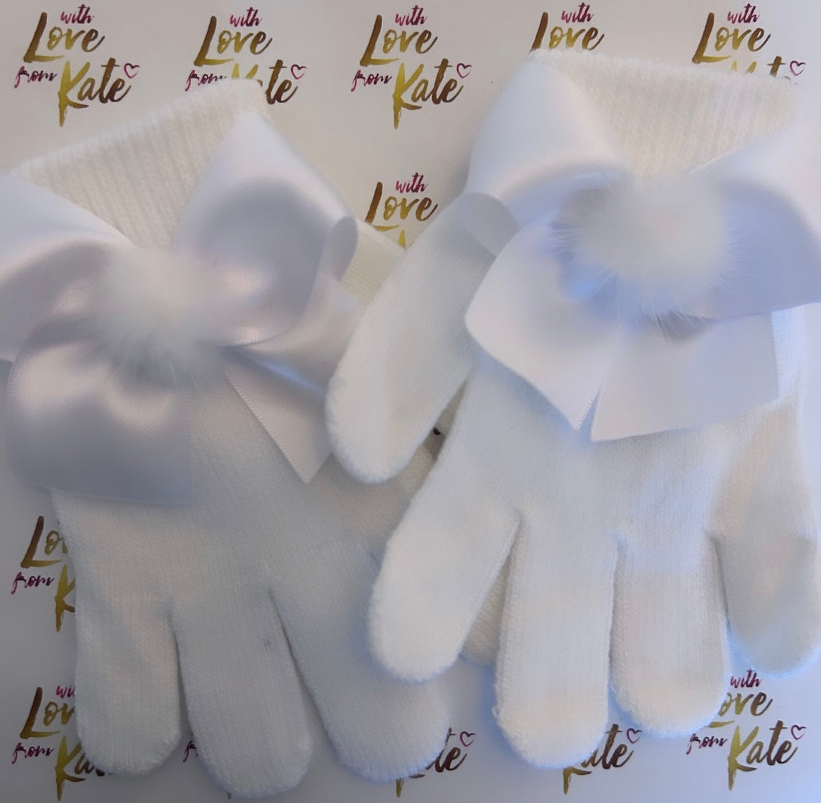 White gloves with satin bows and pom poms