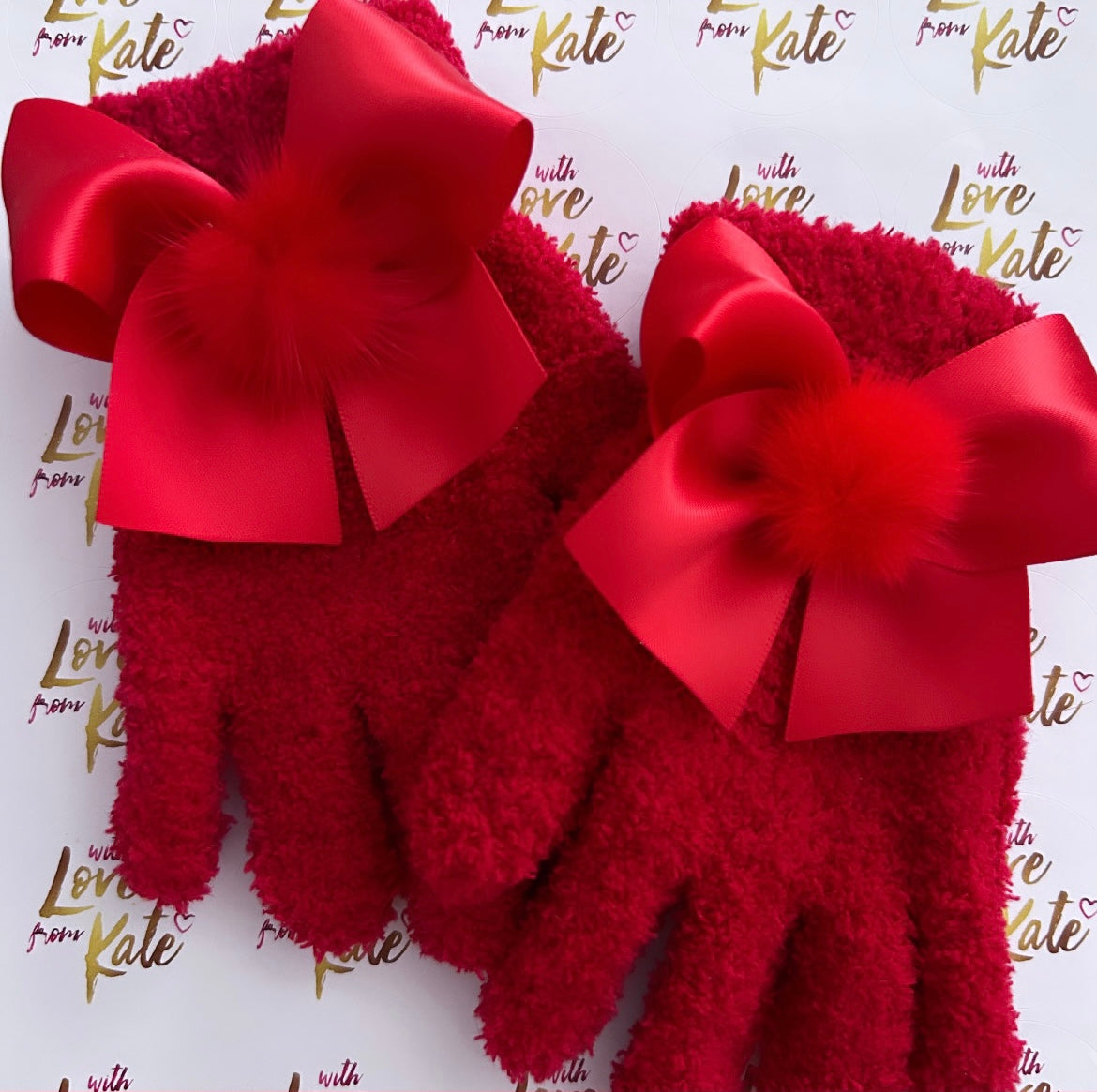 Red fluffy gloves with satin bows and pom poms