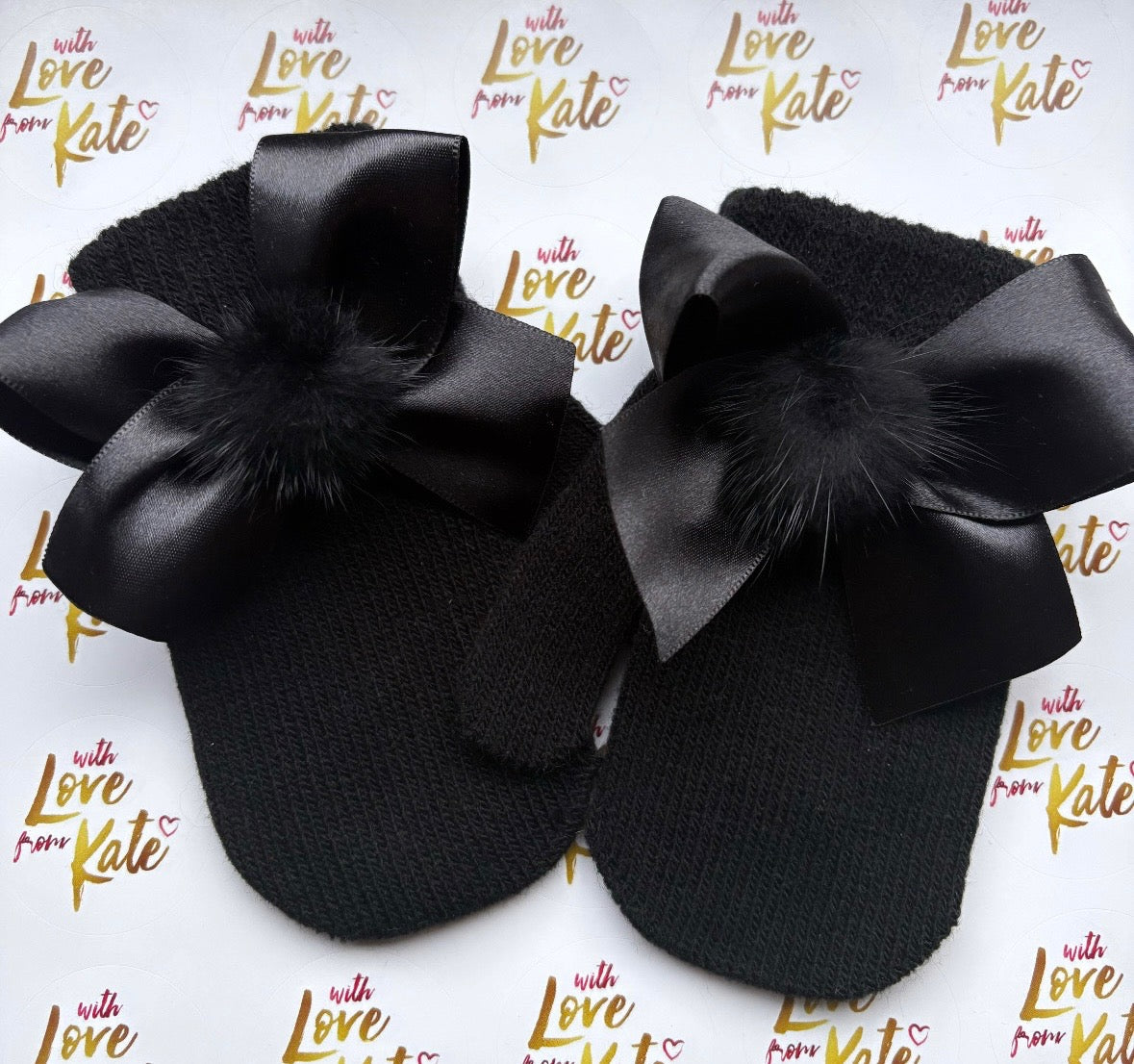 Black toddler mittens with satin bows and pom poms