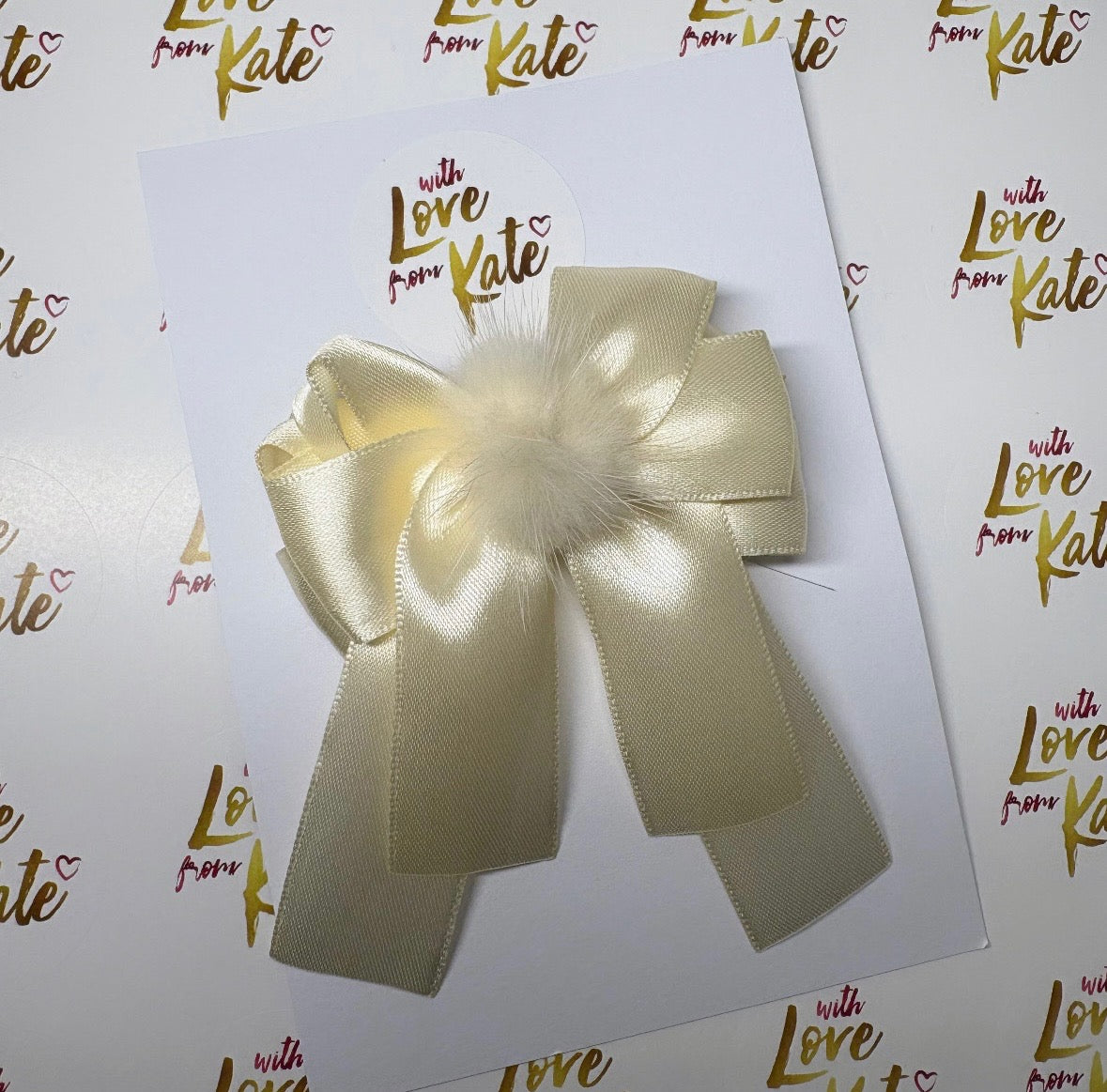 Cream satin ribbon longtail bow with pom pom