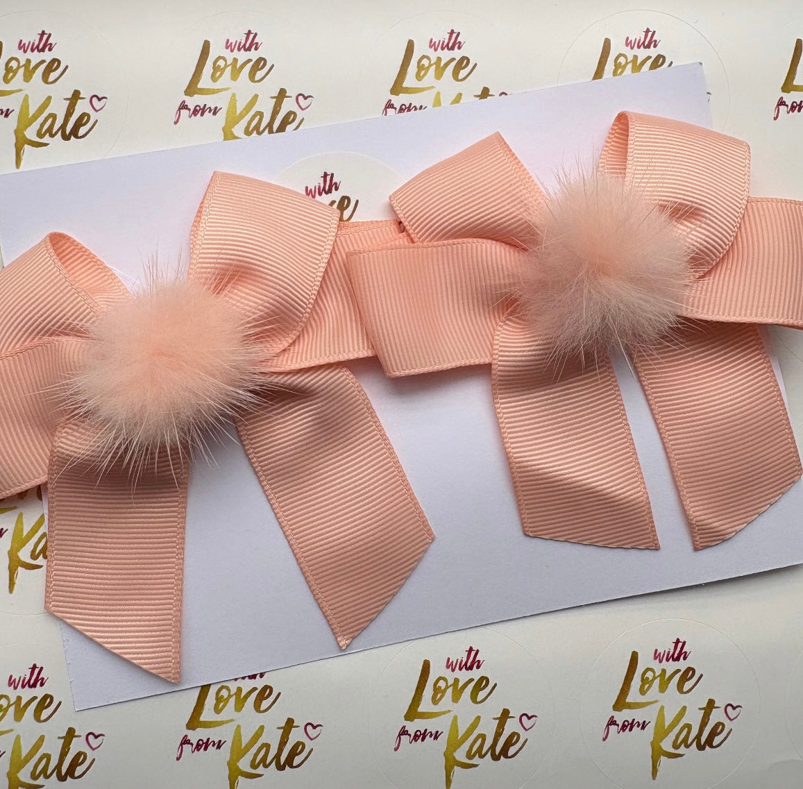 Peach longtail bow with pom pom