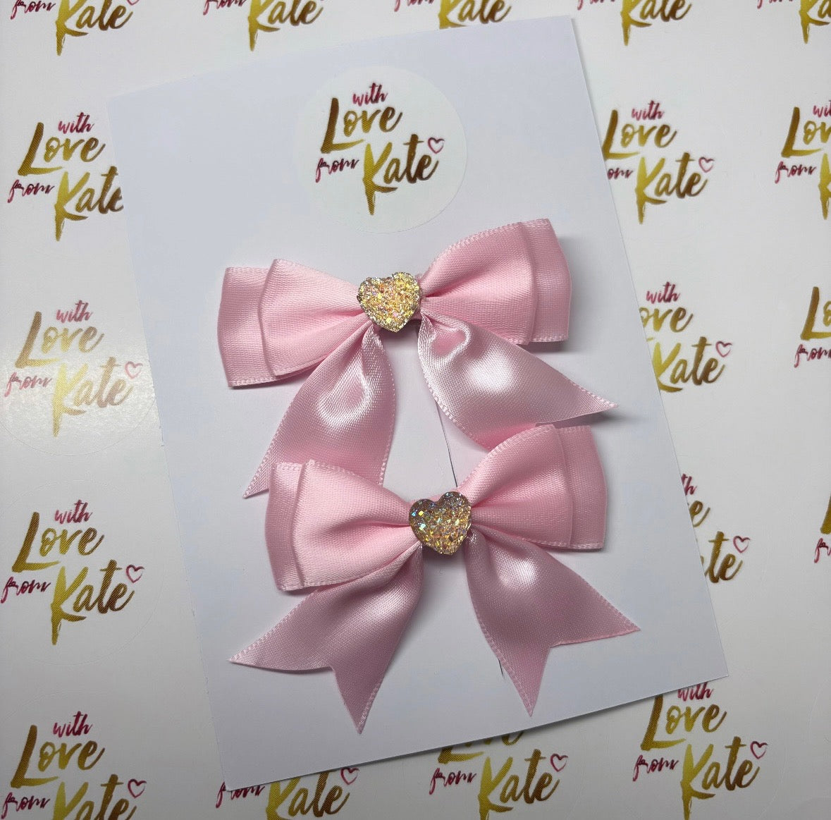 Pink satin pinch split bows with heart centres