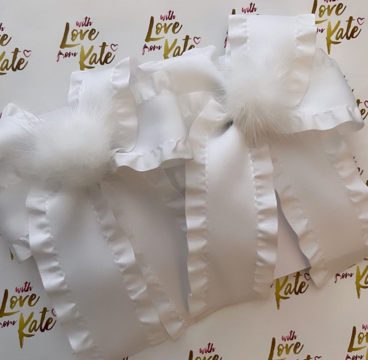 White ruffle ribbon longtail bow with pom pom centre