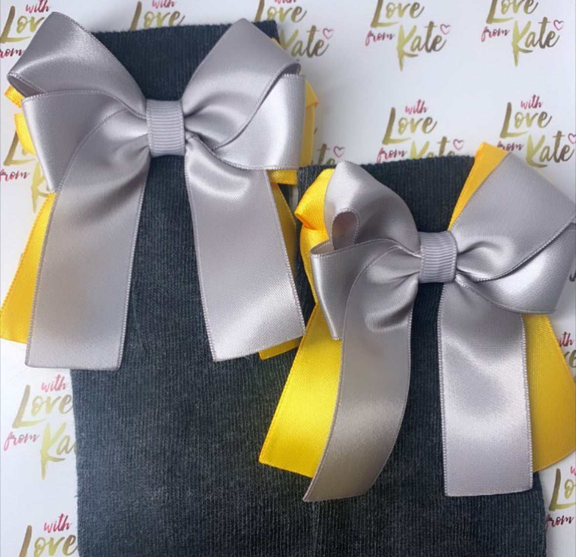 Grey socks with grey and yellow long tail bows