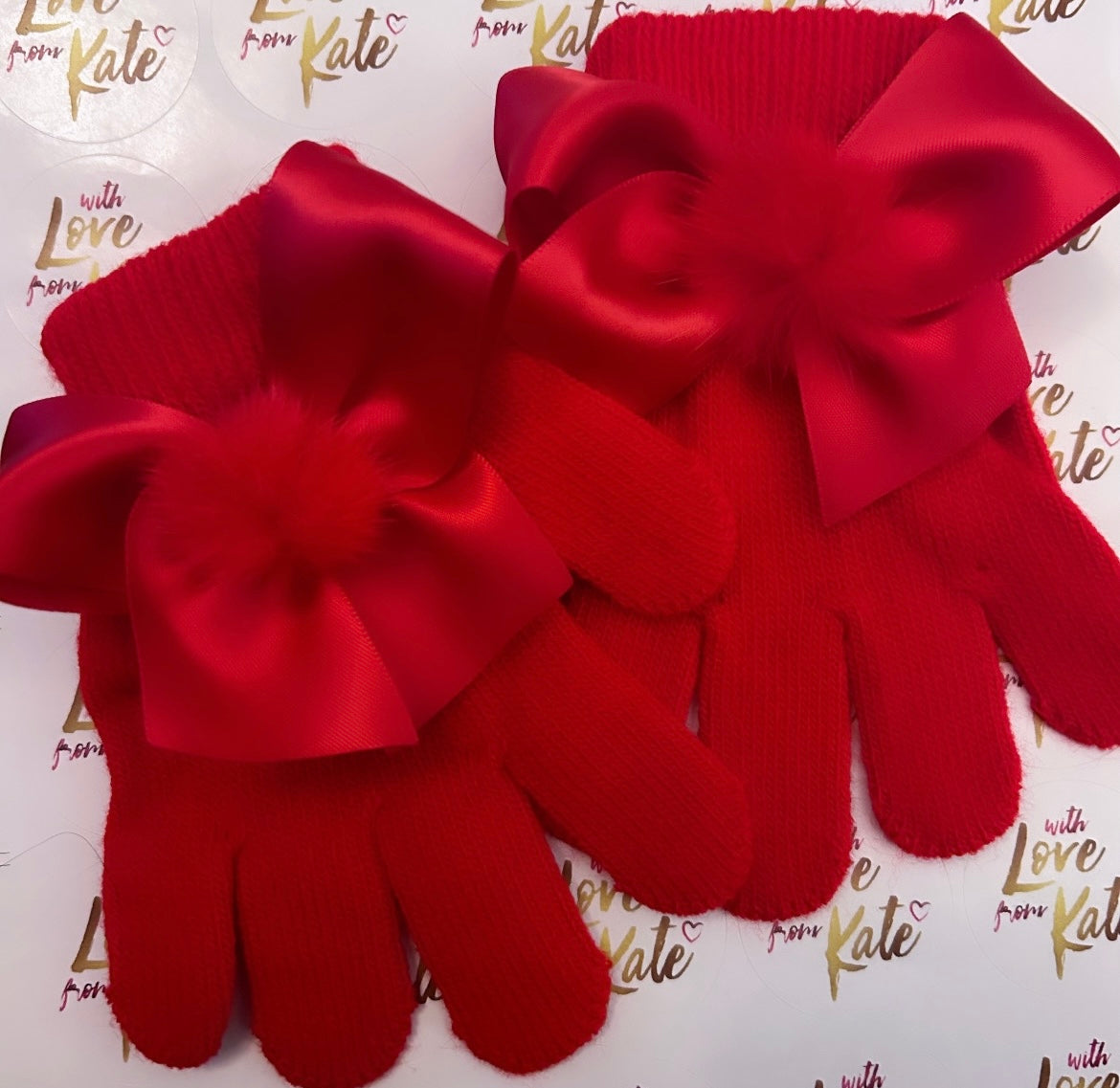 Red gloves with satin bows and pom poms