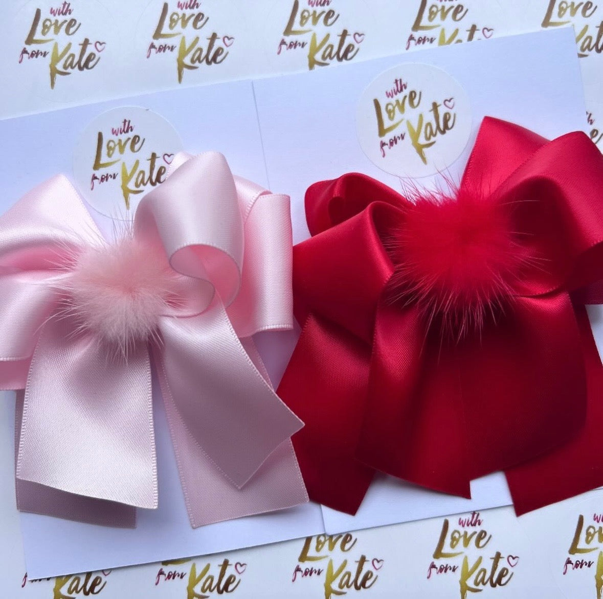 A set of 1 Red & 1 Pink XL short tail bows with Pom Pom centres