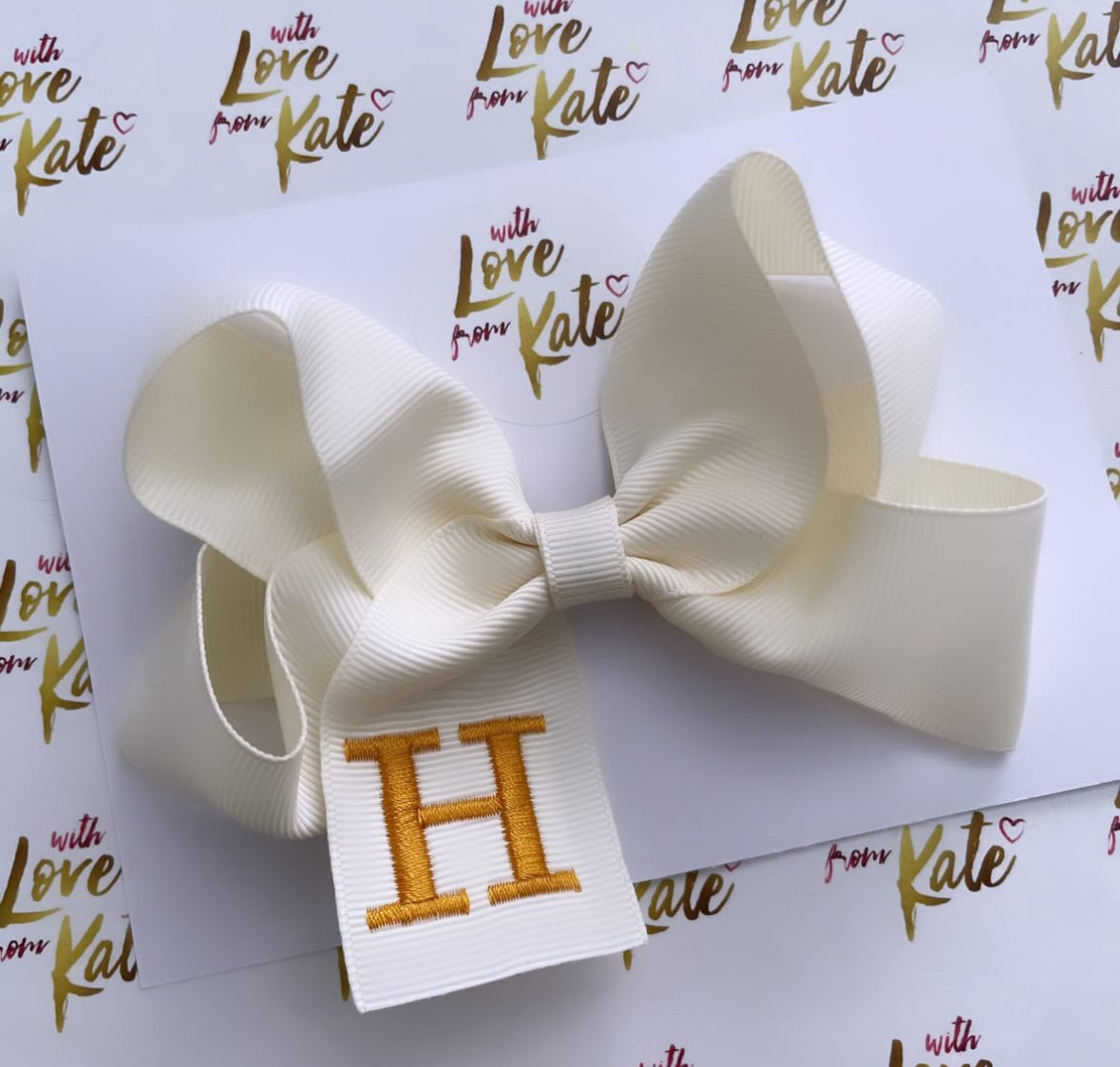 Cream with gold embroidered initial boutique bow