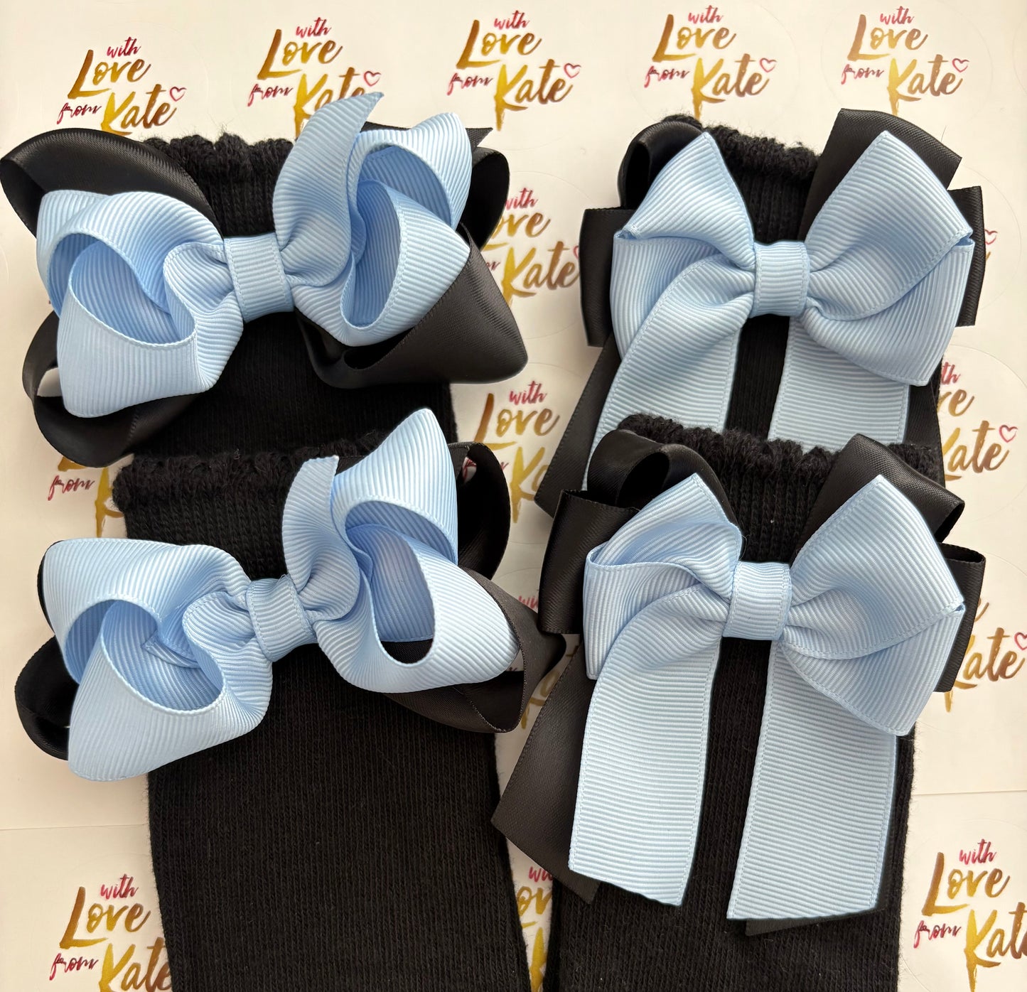 2 pairs of black socks with black & powder blue bows