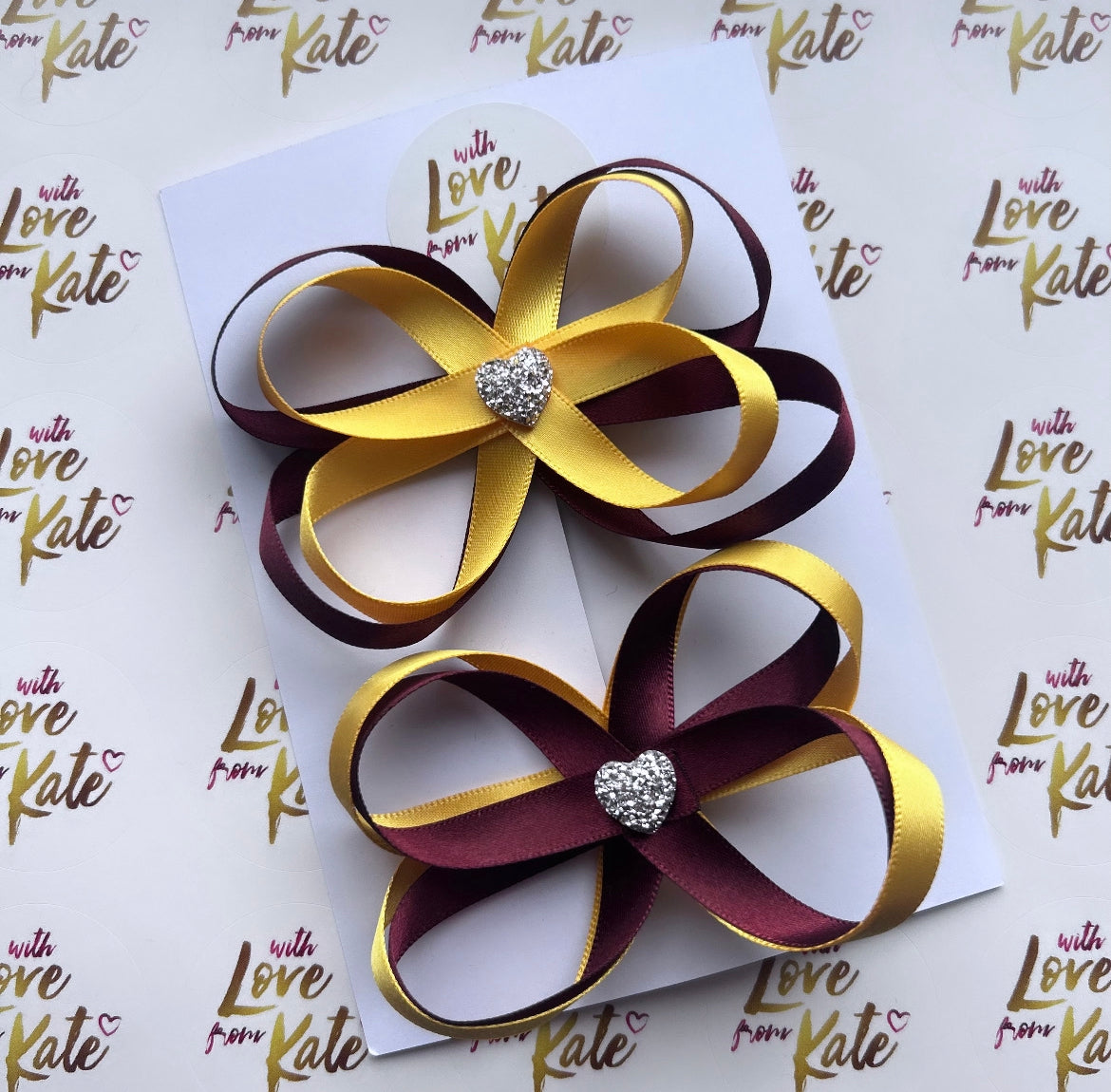 2 x maroon & yellow satin butterfly bows with heart centres