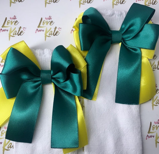 White socks with green and yellow long tail bows