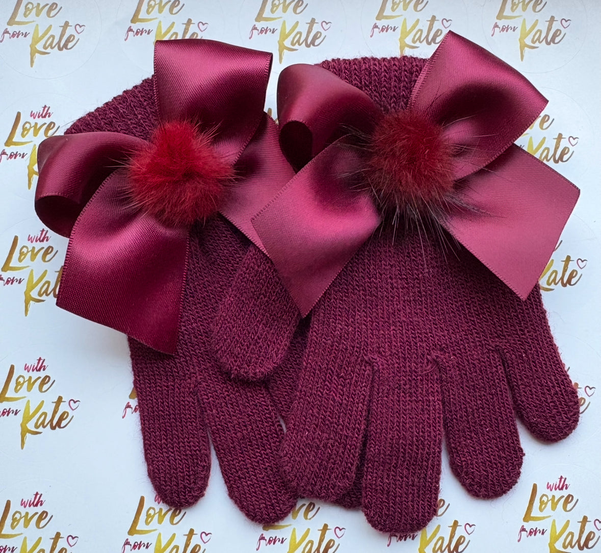 Maroon gloves with satin bows and pom poms