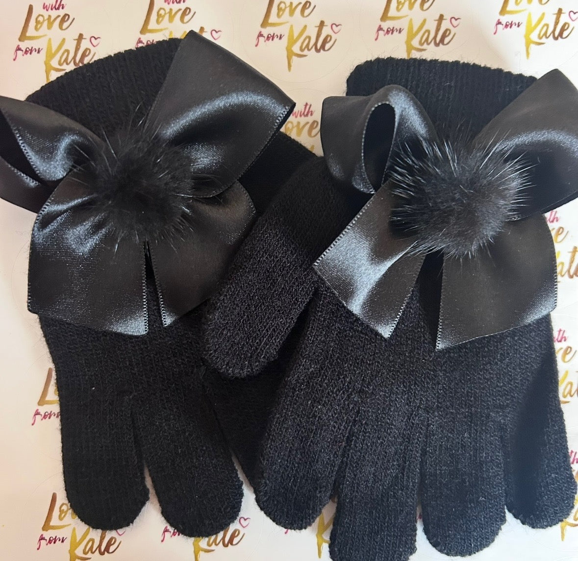 Black gloves with satin bows and pom poms