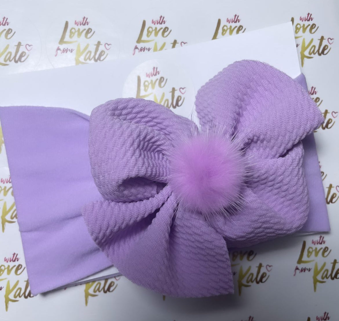 Lilac textured knot baby headband with pom pom centre