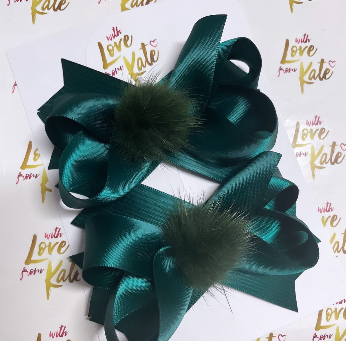 Dark green pom pom stacked bow