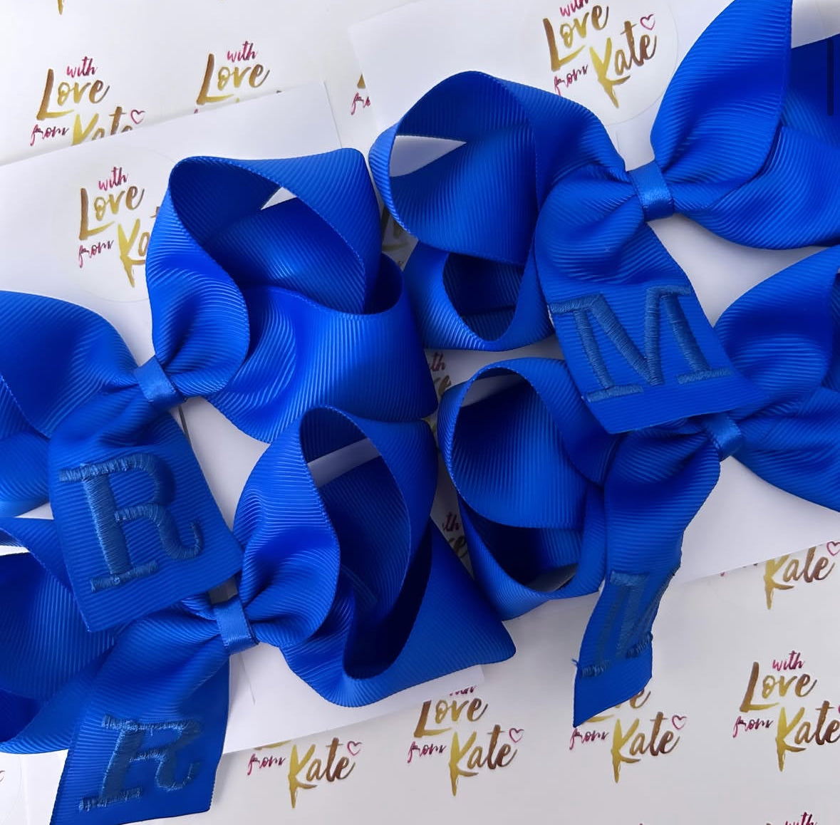 A royal blue boutique bow with royal blue embroidery