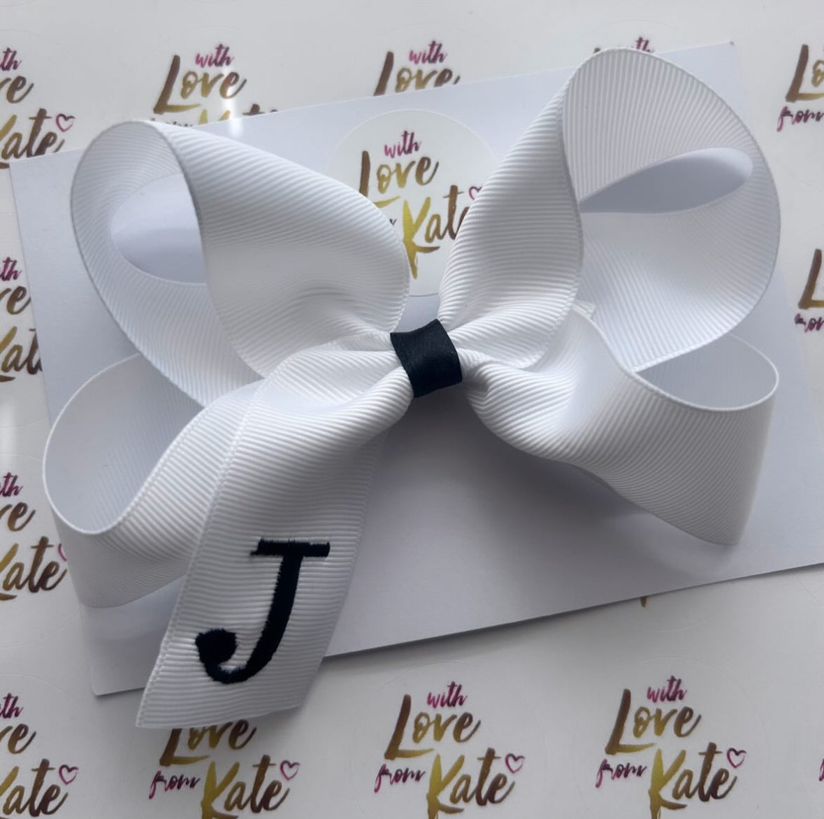 White with black embroidered initial boutique bow